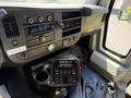 Interior view of a 2017 Chevrolet Express showing dashboard controls radio air conditioning and a control panel with buttons