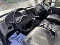 Interior cockpit of a 2012 International DuraStar 4300 with a steering wheel dashboard gauges and control panel featuring various buttons and levers