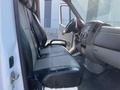 Interior of a 2016 Mercedes-Benz Sprinter showing black front seats and dashboard with controls and a steering wheel