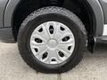 Close-up of a silver wheel with a distinct design and black tire labeled Good Year mounted on a 2017 Ford Transit T150 XLT