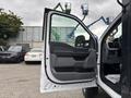 A 2023 Ford F-450 Super Duty with an open front door showcasing a gray interior and control panel visible inside