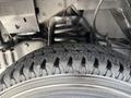 Close-up of a tire from a 2012 Ford Econoline showing the tread pattern and detail of the wheel rim
