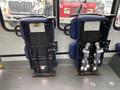 Two blue seats from a 2020 Chevrolet Express are shown in an upright position with metal frames and seatbelts visible