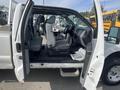 A 2014 Ford F-250 SD with an open door showing the interior featuring gray seats and a dashboard
