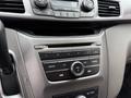 The interior dashboard of a 2014 Honda Odyssey featuring a central control panel with radio and climate controls, a CD player, and a knob for adjusting volume and settings