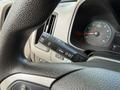 A close-up view of the steering wheel and control stalk of a 2018 Chevrolet Colorado featuring buttons for setting cruise control and menu navigation