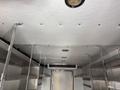 Interior view of a 2017 Freightliner MT45 with a white ceiling and metal shelving on both sides