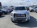 A 2015 Ford F-150 pickup truck in silver color with a prominent front grille and logo visible