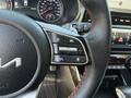 Close-up of the steering wheel controls of a 2024 Kia Forte5 featuring buttons for audio settings and driver assistance functions