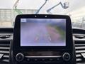 A dashboard display of a 2020 Ford Transit 250 showing a rearview camera view with guidelines for parking assistance
