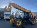 A yellow 2013 JCB 510-56 Loadall with a telescopic boom and attached fork arms positioned upright
