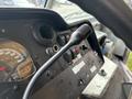 Close-up of the dashboard of a 2012 Ford E-450 Super Duty featuring gauges and control knobs with a gear shift lever prominently displayed