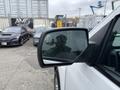 A 2016 GMC Sierra 1500 with a side mirror reflecting a person holding a camera