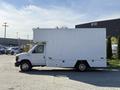 A white 2012 Ford Econoline E-450 box truck parked with a large cargo area and side entrance door