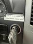 A close-up of the ignition area in a 2009 Dodge Sprinter Van showing the key in the ignition and a label with instructions for starting the motor