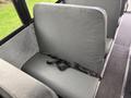 Interior seating of a 2022 Freightliner B2 bus featuring gray upholstery and a safety belt on the seat