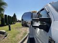 A 2017 Ford F-550 truck with a large side mirror showcasing a shiny reflection and a sporty design