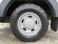 Close-up of a silver wheel with a rugged tire mounted on a 2015 Ford F-350 SD