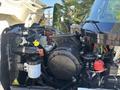 A 2013 International 7500 engine compartment showing various components including an air filter housing hoses and electrical connections