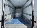 A 2016 Mercedes-Benz Sprinter with an empty cargo area featuring blue flooring and metallic strips along the walls