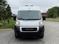 A 2020 RAM Promaster van viewed from the front with a white exterior and prominent RAM logo on the grille