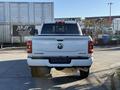 A 2023 RAM 3500 truck viewed from the rear showcasing the tailgate with the RAM logo and 4x4 badge