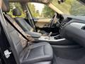 Interior view of a 2013 BMW X3 showcasing black leather seats and a modern dashboard design