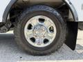 A close-up of a chrome wheel of a 2020 Ram 2500 with an all-terrain tire showing the tread pattern and lug nuts