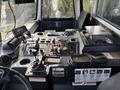 Interior view of a 2011 Autocar Xpeditor truck with a dashboard featuring various buttons levers and controls