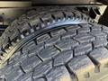 Close-up of two rugged tires stacked on a 2017 Ford F-650 Super Duty showcasing deep treads designed for heavy-duty performance and off-road capability