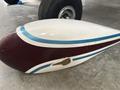 A close-up of a 1986 Sorrell Hiperbipe SNS-7 aircraft fuselage section featuring a maroon and white design with blue stripes and a small dent visible on the surface