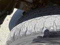 Close-up of a tire from a 2015 RAM 1500 showing detailed tread patterns and wear indicating usage