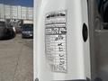 A service label attached to a white 2020 Chevrolet Express detailing performed maintenance mileage and service items completed