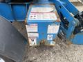 A rusted metal control box with warning labels on a 2016 Genie TZ-34/20 aerial lift machine