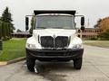 A 2006 International 4200 truck with a white exterior and a prominent chrome grille facing forward