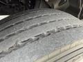 Close-up of a worn tire from a 2019 Ford F-750 showing significant tread wear and visible damage on the surface