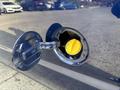 Close-up of a yellow fuel cap on a 2013 Ford E-350 Super Duty's fuel filler neck