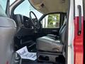 Interior of a 2007 GMC C4500 TopKick showing the driver's seat steering wheel and dashboard with a thank you note on the floor