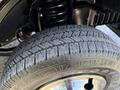 Close-up of a tire from a 2021 Ford Econoline showing tread pattern and shiny rim