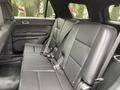 A 2019 Ford Explorer with a spacious black leather interior featuring three rear seats and seatbelt attachments