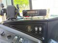 A 2009 International 3000 CE dashboard featuring a radio unit and various control buttons for fan and driver heater functions