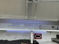 A 2016 RAM 1500 truck interior with LED strip lighting and a small storage container visible on a white surface