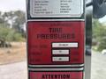 A label on a 2012 Caterpillar 980 displaying recommended tire pressures for tire size 29.5R25 with front at 75 lbs and rear at 50 lbs