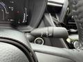 A close-up view of the steering wheel and control stalk of a 2025 Toyota Corolla showing various functions and controls for driving