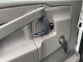 Close-up of the door handle and interior panel of a 2020 Chevrolet Express with a smooth texture and a lever for window operation