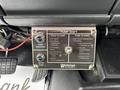 Control panel for pump operation in a 2002 GMC C7500 featuring buttons for engaging the pump and shifting the transmission