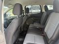 The interior of a 2014 Ford Escape showing the back seats with fabric upholstery and a center armrest with cup holders