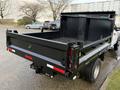 A 2017 Ford F-450 Super Duty truck with a black dump bed visible in the foreground