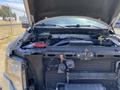 A 2014 Ford F-150 with the hood open showing the engine compartment and various mechanical components
