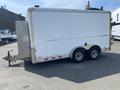 A 2008 Wells Industries Inc EW1422 trailer with a white exterior and dual axles positioned at an angle showing the side and rear views